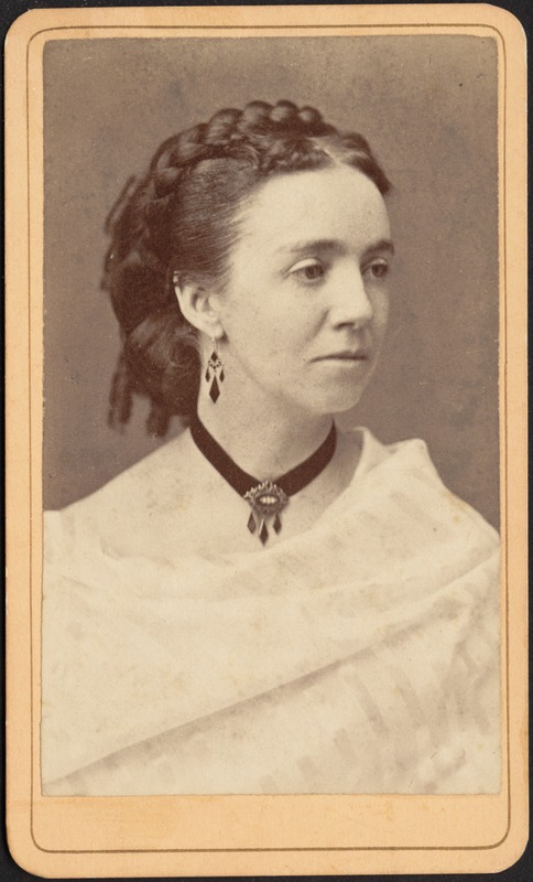 Woman in white shawl with jet earrings and choker, braided coiffure with ringlets in back (head/shoulders)