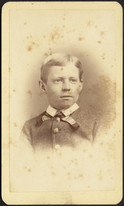 Young boy in striped tie and stiff white collar, brass buttons
