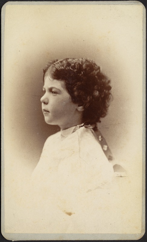 Profile of young child with dark curly hair