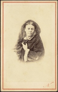 Woman in lace scarf, long earrings, brooch, dark dress (head and shoulders)