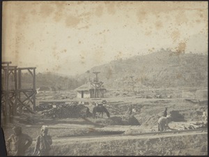 Construction site and rail tracks (possibly railroad station construction); men in foreground