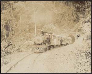 Railroad engine #50 and cars emerging from a mountain tunnel, possibly Jamaica