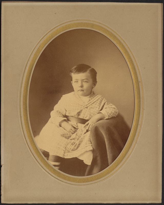 Studio portrait of a young boy, seated, possibly Berry family