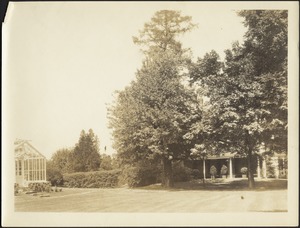 View of grounds; greenhouse on left; house porch on right
