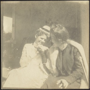 Isabel Stevens in nurse uniform (left) sitting outdoors with unidentified woman