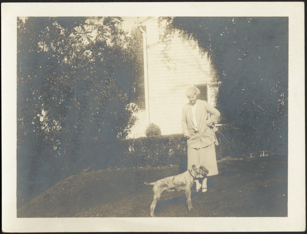 Helen Steven Coolidge standing on lawn with dog