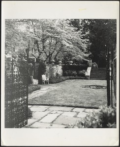 Ashdale Farm. View of rose garden from gate; white cast iron chairs on left
