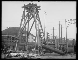 Distribution Department, Low Service Pipe Lines, Chelsea North Bridge Tunnel, hoisting 24-inch pipe into the tunnel, Mystic River; Charlestown; Chelsea, Mass., Jan. 25, 1901