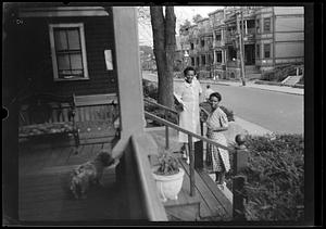 Lottie Miller and another woman on steps, dog in the foreground