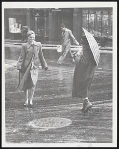 Sloshing Through Slush in yesterday's storm at Tremont and Boylston streets corner yesterday were these hardly feminine citizens. Left: a frustrated woman contemplates the cost of a new umbrella after her plaid job collapsed in the wind. Center: another lady grimaces after having been soused by a passing truck. Right: one little gal could even smile even though she wore no protection for her shoes.