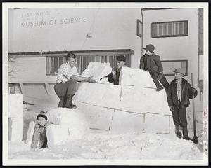 "Spring" Construction Project at the Museum of Science features an igloo. Richard Kleber of the museum staff and director Bradford Washburn (center), are the builders. Watching them are (left to right) Teddy Washburn, Mark and Chris Solomon, all of Cambridge.