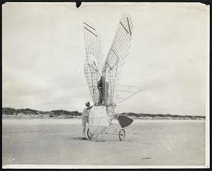 To Fly as Sea birds Soar--Maybe.- St. Agustine, Fla.--George R. White, of Stony Brook, L.I., former army aviator, who for six years had devoted himself to mechanically approximating the flight of birds, recently completed. the assembling of his motorless ornithopter, in which he will attempt the first birdlike flight, at St. Augustine, Fla.- The Ornithopter will carry a gross weight inclusive of the inventor of 278 pounds and once in the air, a beating of wings by feet in a seventeen foot arc at the rate of eighty per minutes, should sustain flight, according to the inventor. Photo shows George White and his Queer Machine.