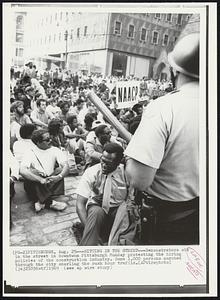 Sitting in the Street-- Demonstrators sit in the street in downtown Pittsburgh Monday protesting the hiring policies of the construction industry. Some 1,000 persons marched through the city snarling the rush hour traffic.