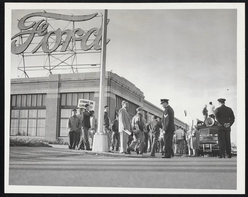 Auto workers on strike in front of a Ford building - Digital Commonwealth