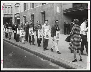 Pickets Parade in front of downtown Boston building of New England Telephone Company. It was one of 500 offices and installations struck in New England yesterday by International Brotherhood of Telephone Workers.