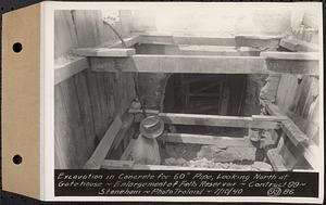 Contract No. 99, Enlargement of Fells High Level Distribution Reservoir, Stoneham, Malden, Melrose, excavation in concrete for 60 inch pipe, looking north at gatehouse, enlargement of Fells Reservoir, Stoneham, Mass., Jul. 10, 1940