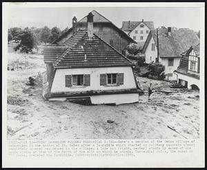 Swiss Landslide Follows Torrential Rains--Here's a section of the Swiss village of Schmerikon in the canton of St. Galen after a landslide which started on Goldberg mountain almost completely covered residences in the village. A lone man (right, center) stands by eaves of one house giving an idea of the depth of the silt on which he stands. Torrential rains, the worst in 777 years, preceded the landslide.