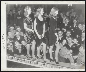 Nothing's Too Good for the Veterans said these New York showgirls. Convalescent vets at Coney Island's Seagate Naval Hospital picked the winners in a "Best Legs on Broadway" contest. Wearing no-seam nylons, the girls stood behind a curtain which showed only their legs and winners selected by applause. The winnahs! (left to right) Elaine Corbett, 3d place; Dee Turnell, 2nd choice, and Janice Bodenhoff, the best.