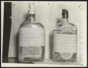 Bottles Seized After Alcohol Deaths. Two of the bottles seized by Gloversville, N.Y., police after eight deaths from poisoned alcohol on Jan 20 are shown above. The strips of paper pasted across the front of each is the police notation as to where, when and by whom each bottle was purchased. In addition to the deaths on Jan 28, seven more died at Gloversville on Jan 29. in all, 32 had died of poison alcohol in up-state New York on Jan 30.