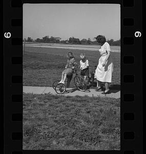 Woman with two children and tricycle