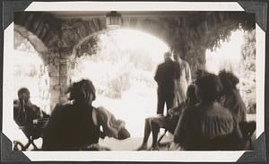 An unidentified group of people, some seated and some standing