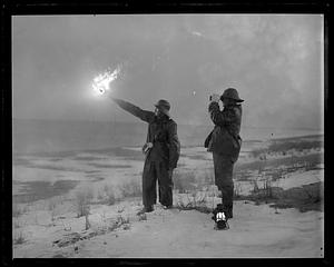 A man holding a lit flare