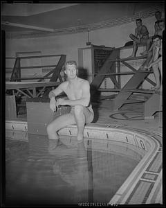 Springfield College swimmer sitting at edge of pool