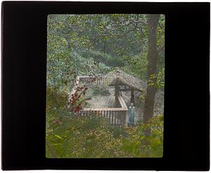 Man standing next to animal enclosure