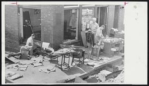 Flood-Swirled Mail Box caused most of this trouble in Thompsonville, Conn. It was jammed through a window, spun around inside the building, and went out another window, disrupting office of Textile Workers Union of America. Here they sort out important records.