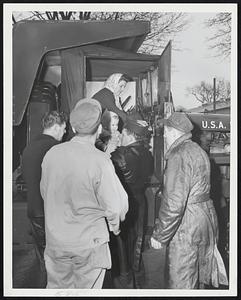 Evacuees from flooded area in Winthrop aided from Army truck.