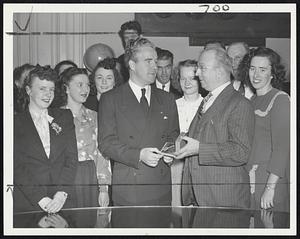 Mayor Surprised on Birthday - Mayor John E. Kerrigan (left) receives a gold watch from his office staff on his 38th birthday today at City Hall. Presentation was made by his chief secretary, John J. Foley.