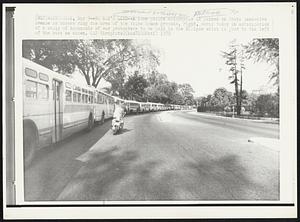 No Man's Land -- A lone police motorcycle is parked on South Executive Avenue as busses rong the area of the White House grounds, right, early today in anticipation of a rally of thousands of war protesters to be held in the Ellipse which is just to the left of the busses es shown.