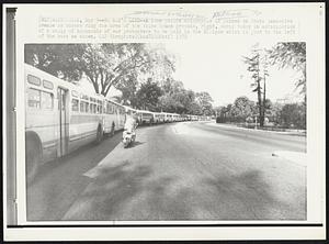 No Man's Land -- A lone police motorcycle is parked on South Executive Avenue as busses ring the area of the White House grounds, right, early today in anticipation of a rally of thousands of war protesters to be held in the Ellipse which is just to the left of the busses es shown.