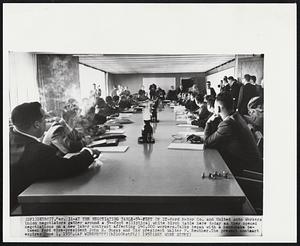 At the Negotiating Table-54-Feet of It-Ford Motor Co. and United Auto Workers Union negotiators on a new labor contract affecting 140,000 workers. Talks began with a handshake between Ford vice-president John S. Bugas and UAW president Walter P. Reuther. The present contract expires June 1958.