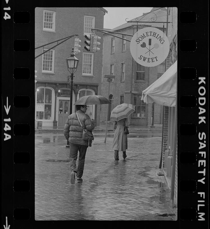 People with umbrellas in the rain