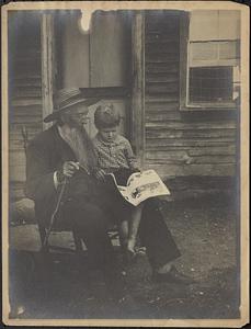 Old man reads to child