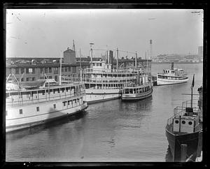 Docked ships and boats, including "Neptune" and "Newcastle"