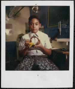 Boy sitting and holding an object