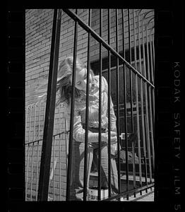 Woman paints railing in Bay Village, Boston