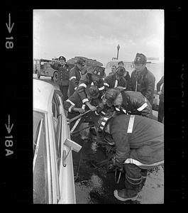 Firemen pry open door of car after accident, Jamaicaway