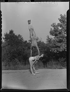 Nick Peters does a handstand off the back of his wife