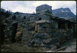 Stone cabin in setting with mountains