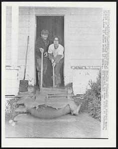 Mr. & Mrs. Joe O'Connell start cleanup operations of their home after Eel River inundated the area 12/25 at Ferndale, Calif., some 15 miles south of here.