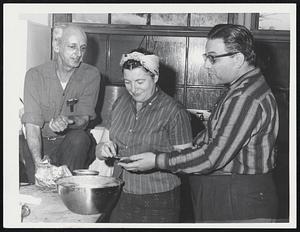 Bite To Eat is mighty welcome when your kitchen is full of sea water. Edward Burke, custodian of Hull Memorial High School, left, chats in disaster kitchen with Mrs. Blanche Hirtle and Henry Stern, both of Lynn avenue.