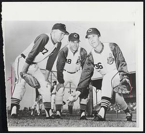 Underhanded Trick is demonstrated by Cleveland Indians hurler Ted Abernathy (right). Abernathy's submarine serve is reminiscent of the delivery used by one-time Red Sox pitcher Eldon Auker. Interested parties are rookie Tommy John (left) and former Baltimore hurler Jerry Walker.