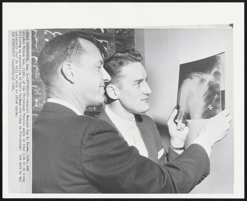 Optimistic -- General Manager Joe L. Brown, left, and pitcher Vernon Law, right, of the Pittsburgh Pirates smile as they look at an x-ray following an examination of Law's injured arm today in Pittsburgh. Law said he was optimistic that he will be able to pitch again.