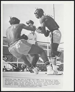 A Flier Goes Down--Fred Burris, a light middleweight from Glen arden, Md., who represents the United States Air Force, heads for the canvass as he suffers a third round knockout in Olympic boxing trials at World's Fair today. The winner was Bill Douglas, a Golden Gloves fighter from Columbus, Ohio.