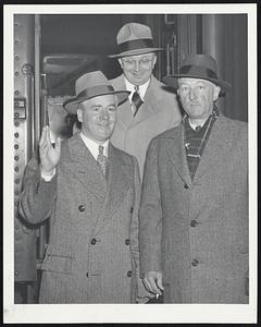 Mayor Kerrigan Returns from trip to New Orleans where he studied juvenile development and recreation programs. The mayor, left, was greeted at the South Station by his secretary, John J. Foley, center, and Douglas Lawson, chairman of his juvenile development committee.