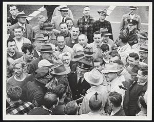 Tense Moment on GE Picket Line. Management officials, shown at right in light hats, sought to enter General Electric Company Lynn plant yesterday but pickets yelled them down, as demonstrated.