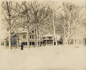 North Main St., South Yarmouth, Mass. looking toward Bridge St., row of houses behind trees, scene thick with snow